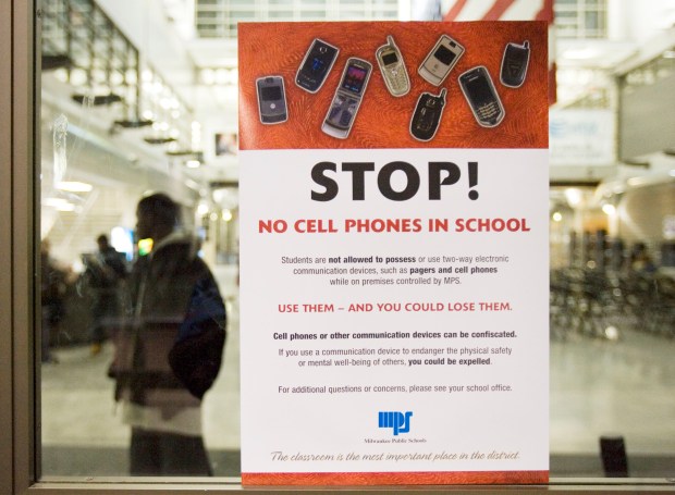 A poster on a door at Bradley Tech High School explains the ban on cell phones Wednesday, Jan. 17, 2007, in Milwaukee. Milwaukee Public Schools Superintendent William Andrekopoulos has told principals they must craft policies banning cell phones and pagers when the second semester starts on Jan. 29, 2007. (AP Photo/Morry Gash)